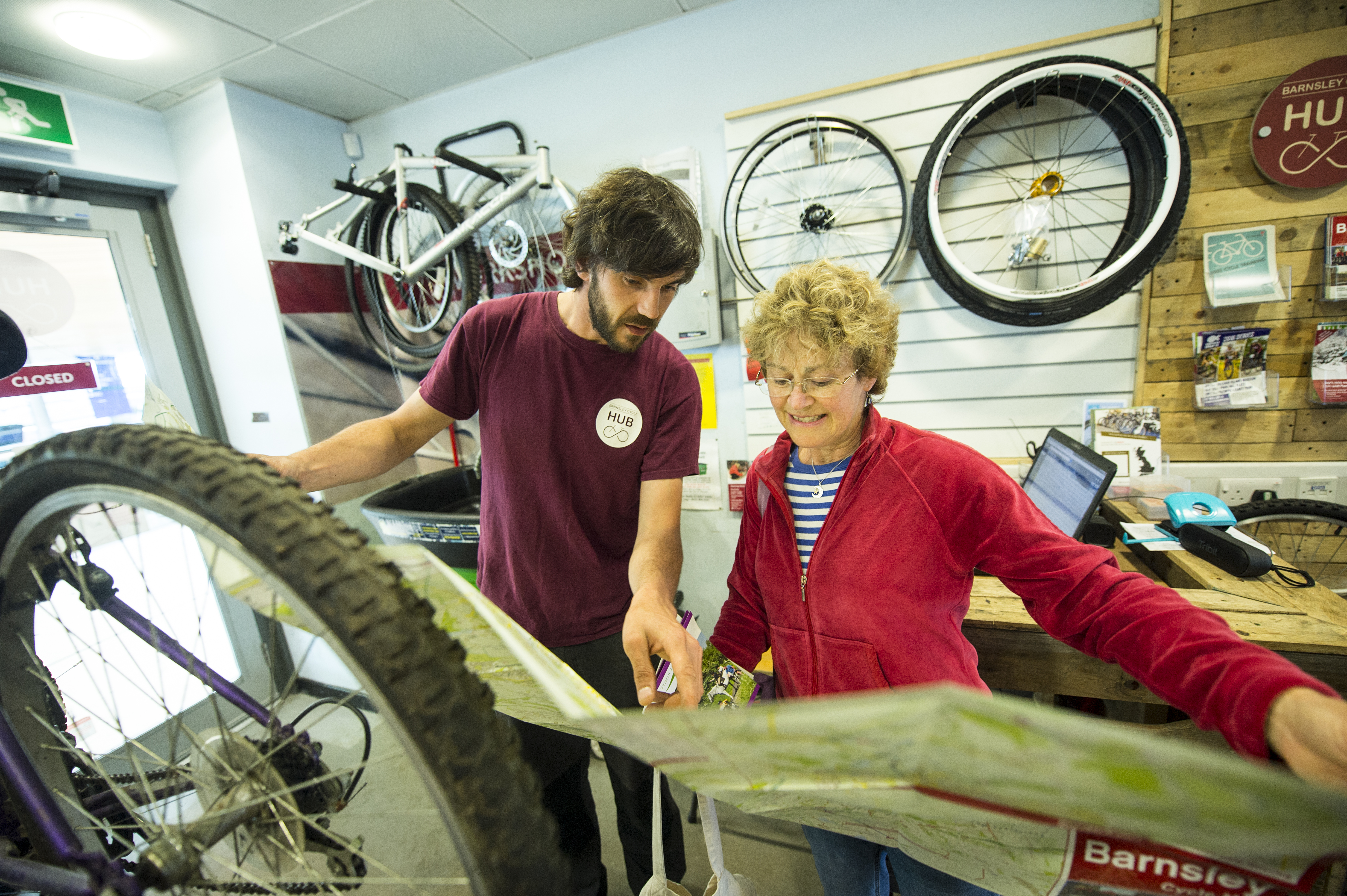 Barnsley Cycle Hub staff looking at map with woman cyclist