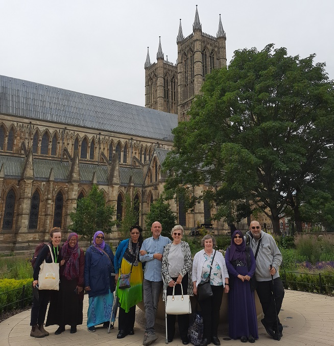 Eight members of the rail group stood facing the camera in front of Lincoln Cathedral